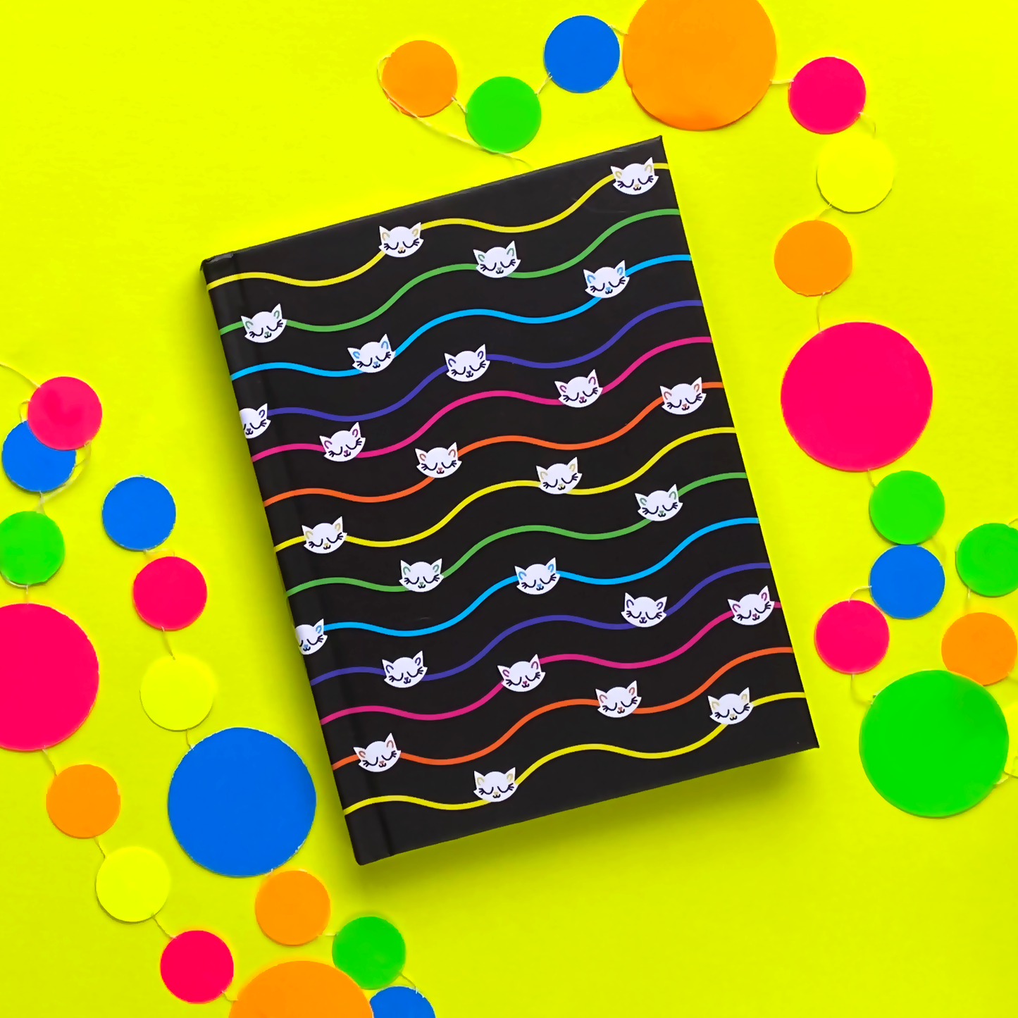 Black journal with wavy rainbow pinstripes and white cats